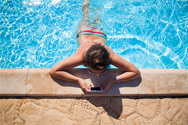 Girl reading in swimming pool