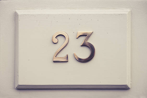 Twenty three (23) door number on white wood stock photo