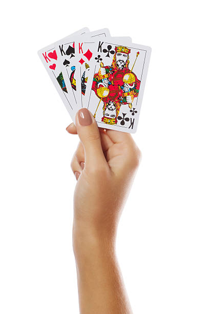 istock Playing cards in hand isolated on white background 486173422