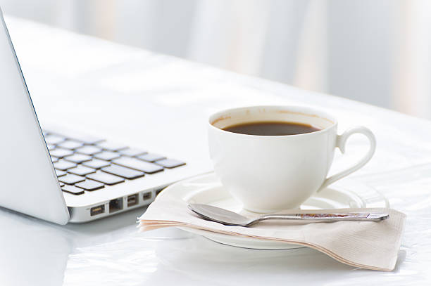 istock Coffee cup and laptop for business 486184116