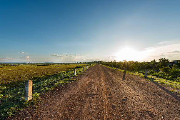istock Rural dusty countryside road with sunset 486184312