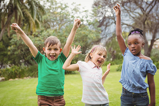 istock Kids celebrating with arms raised 486184564