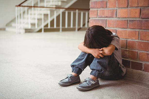 istock Upset lonely child sitting by himself 486184620
