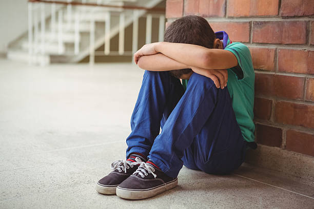 istock Upset lonely child sitting by himself 486184622