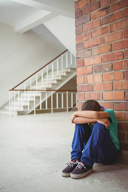 istock Upset lonely child sitting by himself 486184628