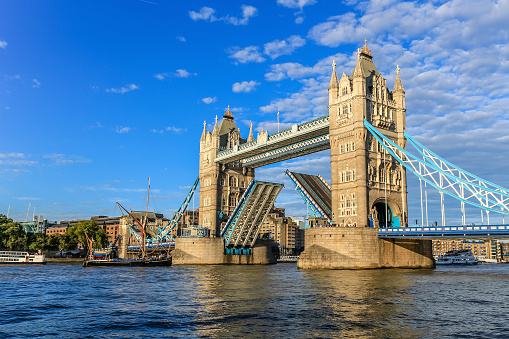 A view of Tower Bridge seen from the middle of the River Thames in London, England. Facing downstream, the South Bank is on the right of the image.