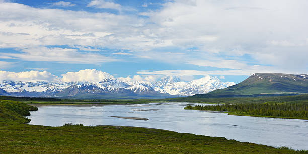 Susitna River in Panorama Susitna River with snow capped mountain ranges in background, Alaska, USA talkeetna mountains stock pictures, royalty-free photos & images