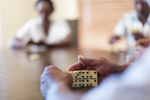 Close up of african hands covering dominos. Langebaan, Western Cape, South Africa.