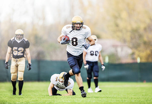 istock American football player running on a playing field. 486200567
