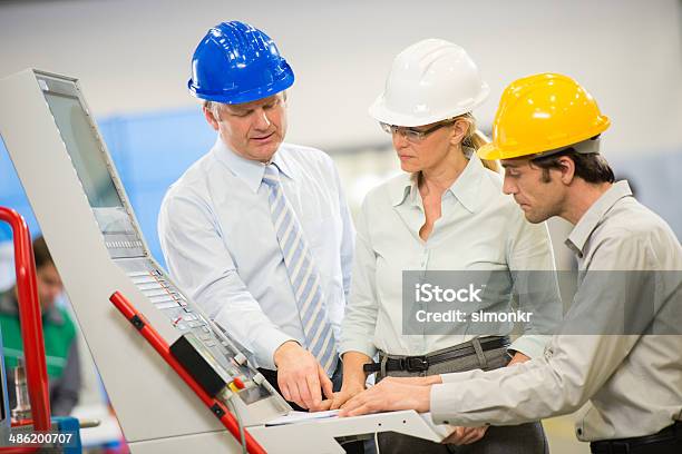 Engineers Programming A Cnc Machine Stock Photo - Download Image Now - Adult, Adults Only, Assistance