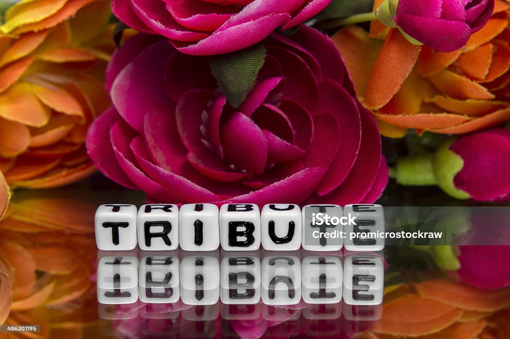 Tribute text and flowers Tribute text and flowers in the background. Alphabet Stock Photo