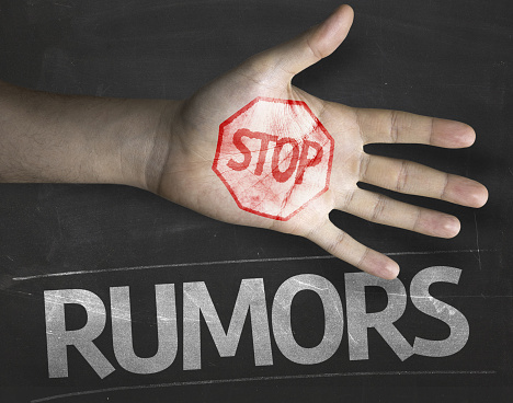 Educational and Creative composition with the message Stop Rumors on the blackboard