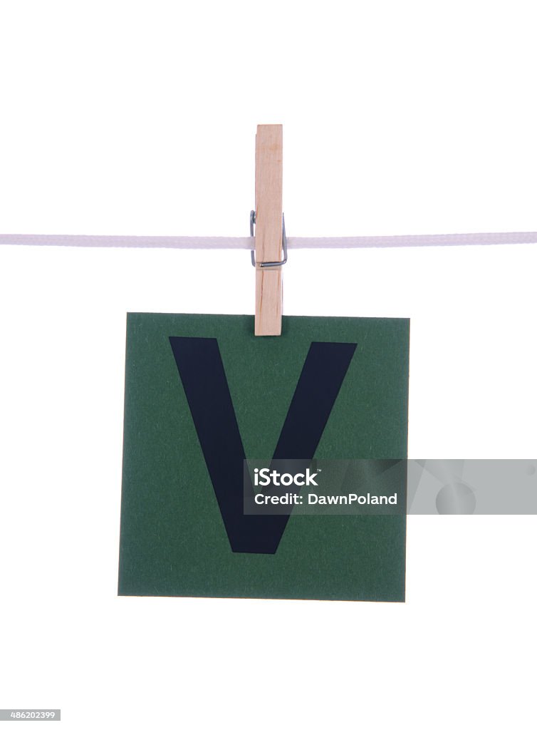 Letter V Letter V on green paper hanging on a clothesline on a white background. Adhesive Note Stock Photo