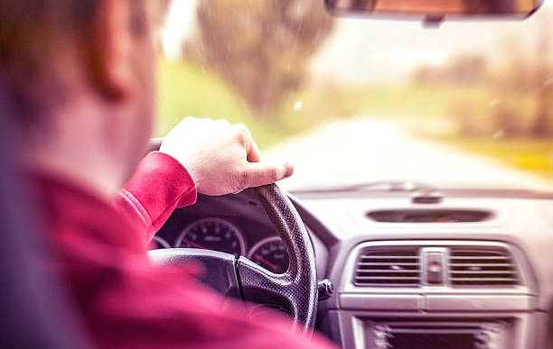 istock Man driving the car on the road 486204301