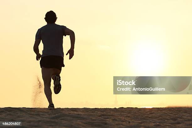 Back View Silhouette Of A Runner Man Running Stock Photo - Download Image Now - Men, Rear View, Running