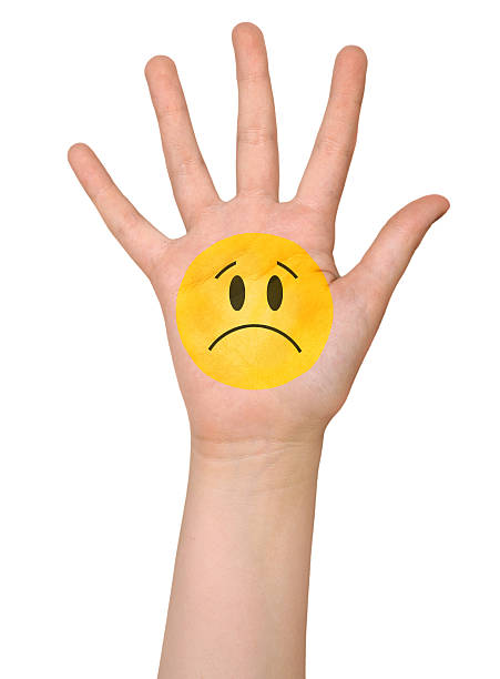 istock sad face icon painting on hand 486204865