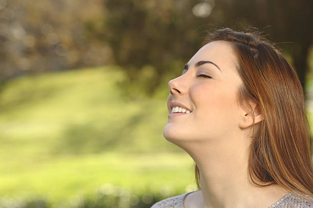 istock Beautiful woman doing breathing deep exercises in a park 486205641