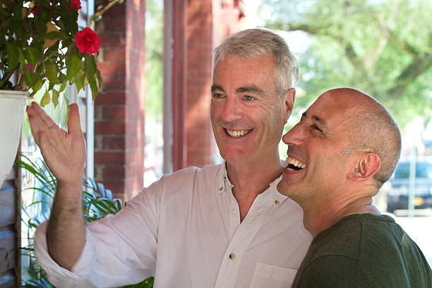 Senior Gay Male Couple Window Shopping on Village Main Street stock photo