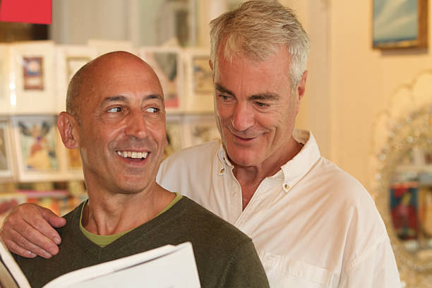 Senior Gay Male Couple Shopping in Home Accessories Store stock photo