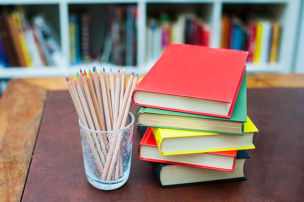 istock Colored pencils with pile of books with colored covers 486227986