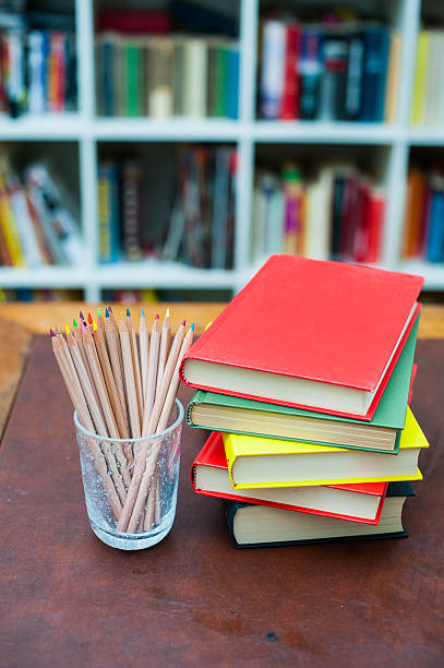 istock Colored pencils with pile of books with colored covers 486227988