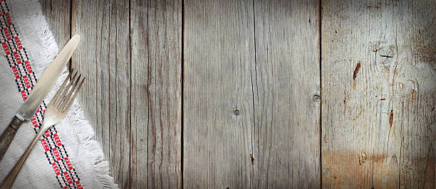 istock Vintage fork and knife on napkin on old wood 486227998