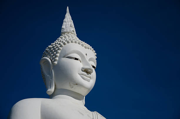 istock Face of Big White Buddha Sculpture In Blue Sky. 486230800