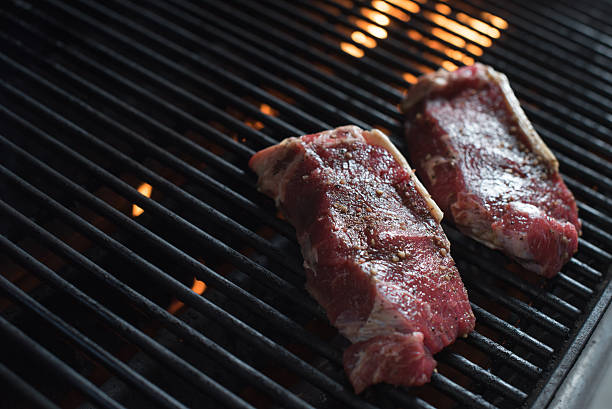 istock NY Strip Steak on grill flames 486232098