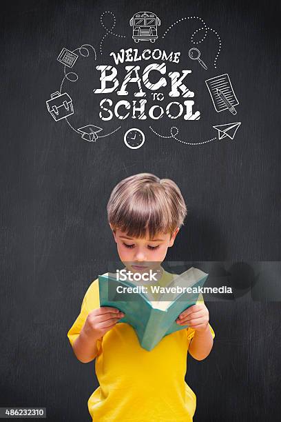 Composite Image Of Pupil Reading Book Stock Photo - Download Image Now - Back to School, 2015, 4-5 Years