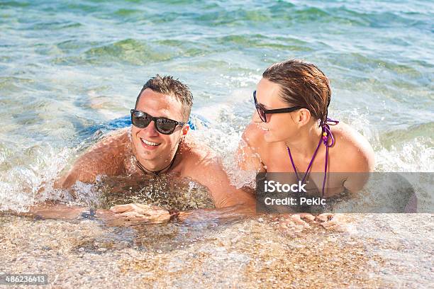 Smiling Couple Enjoying In Water Stock Photo - Download Image Now - Adult, Beach, Beautiful People