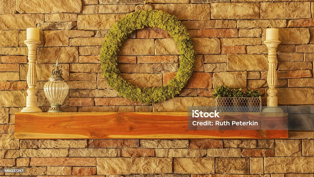 Fireplace Cedar wood mantel on a stone fireplace with decorations Mantelpiece Stock Photo
