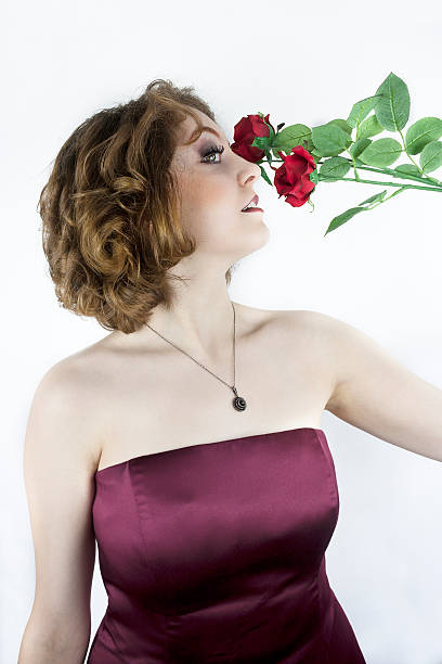 istock Pretty young woman with red roses 486238429