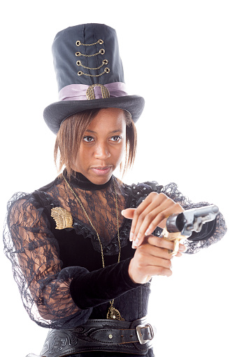 Black girl in Victorian Steampunk clothing posing with her revolver.
