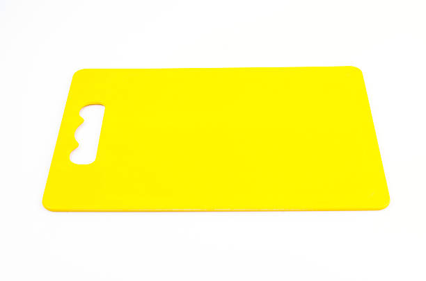 istock Yellow plastic cutting board on isolated white background 486242493