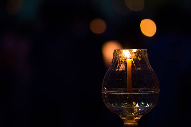 istock Candle flame light at night with bokeh on dark background. 486247684
