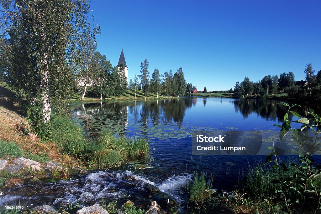 Vuollerim The Church and lake "Kyrktjärn" in the center of Vuollerim a sunny summer day. A nice village along Lule River in northern Sweden.   2015 Stock Photo