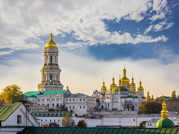 Kiev-Pechersk Lavra against the sky with clouds autumn. Big Bell tower, Refectory Church and Assumption Cathedral. Kiev, Ukraine