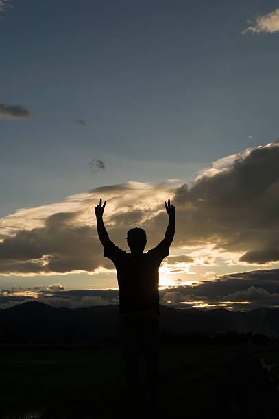 istock man standing alone at the mountain during beautiful sunset 486252542