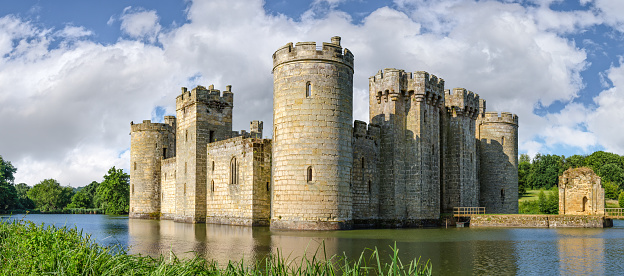 Sussex, United Kingdom - July 9, 2013: Moated castle Bodiam near Robertsbridge in East Sussex, England  was built in 1385 to defend the area against French invasion during the Hundred Years' War.