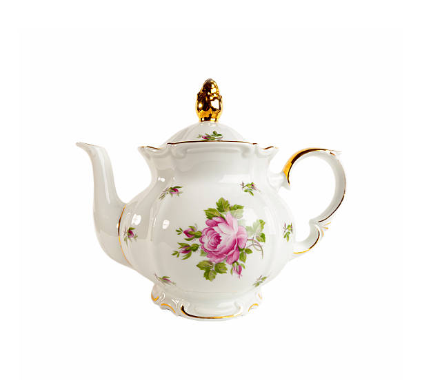 Porcelain teapot in classic style on white Ceramic teapot with ornament of roses and gold in classic style isolated on white vintage tea pot stock pictures, royalty-free photos & images