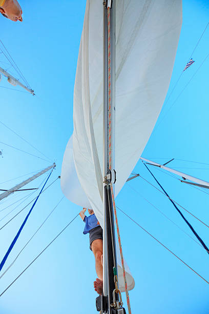 istock Sailing  Team sailors repaired torn sail 486255058