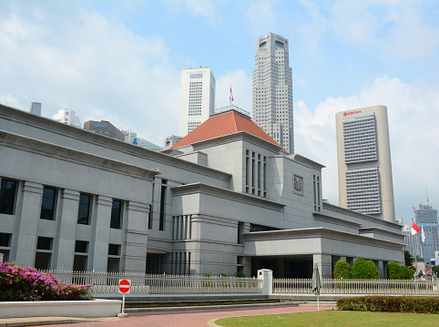 Singapore, Singapore - July 3, 2015: The facade of Singapore Parliament building in front of Singapore downtown. The Parliament and the President jointly make up the legislature of Singapore.