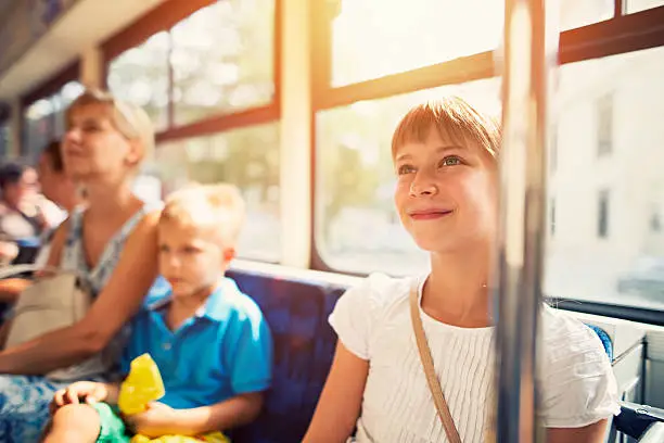Photo of Kids with mother travelling by public transport bus