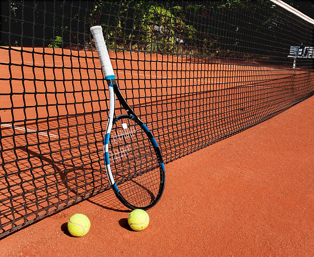 istock Tennis balls and  racket  at the net 486258920