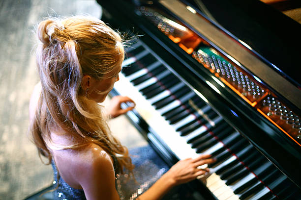 istock Woman playing piano in a concert. 486259032