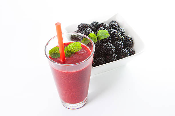 Blackberry smoothie with fruit and mint leaf stock photo