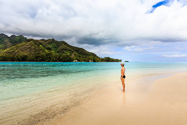 istock Guy Standing Alone in Idyllic Deserted Island in French Polynesia 486259878