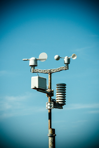 Weather station monitoring equipement against blue sky
