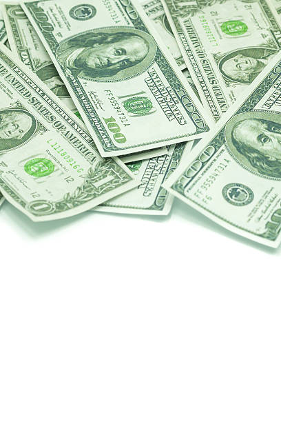 istock One hundred dollars and one dollars pile as background. 486261137