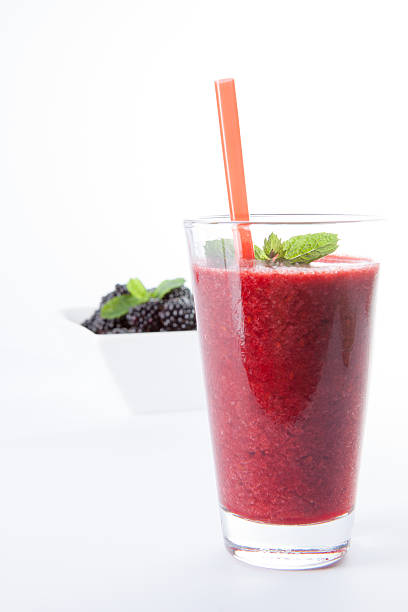 Blackberry smoothie with fruit and mint leaf stock photo